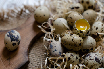 broken quail egg on a wooden board