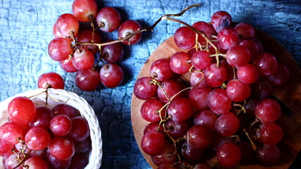 Red grapes on a wooden background