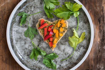Delicious breakfast, heart shape bread service. Healthy lunch with bread and peppers. Diet food background. love food. healthy lifestyle
