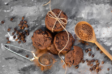 cookies with pieces of chocolate tied with a thread lie on a table sprinkled with cocoa powder