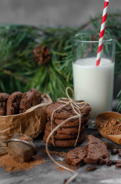 cookies with pieces of chocolate tied with a string on the background of fir branches. Christmas cookies