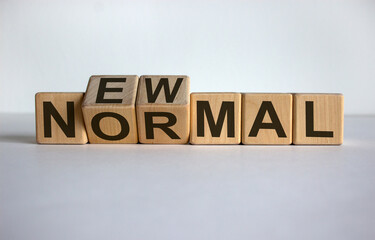 Fototapeta premium Concept words 'new normal' on cubes on a white table. Beautiful white background. Business concept.