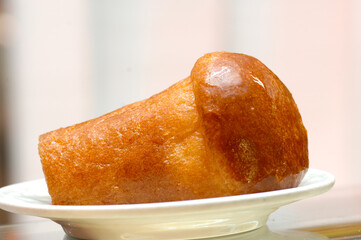 Babà is a  typical cake of the Naples area in southern Italy, white background