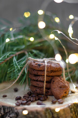 cookies with pieces of chocolate tied with a string on the background of fir branches. Christmas cookies