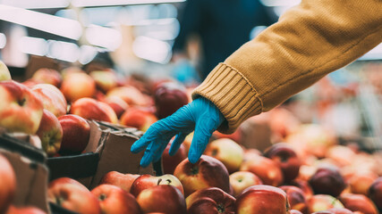 buyer is picking apples in the store . security concept