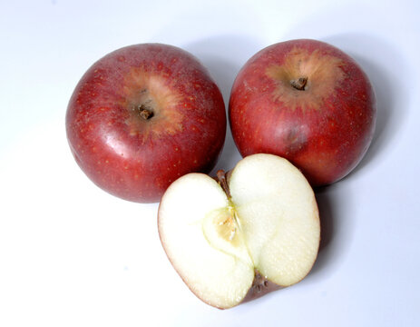 two small red apple called annurca e one opened from the Campania region isolated on white background