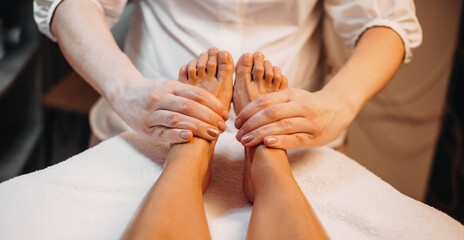 Caucasian masseur having a foot massage session with a client at the spa center