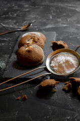 chocolate chip cookies on a table with strawberries and icing sugar