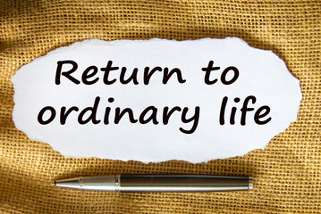 The text 'return to odinary life' on white paper. Metalic pen. Beautiful canvas background....