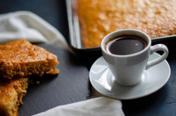 white cup of coffee on a table with a pie