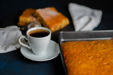 white cup of coffee on a table with a pie