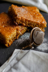 cake on the table sprinkled with powdered sugar