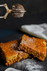 cake on the table sprinkled with powdered sugar