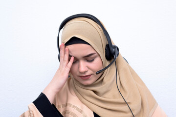 beautifl young muslim female with hijab scarf customer representative business woman with phone headset helping and supporting online with customer in modern bright call centre isolated.