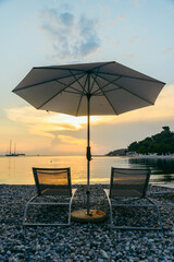 view of sea beach with sun loungers and umbrellas
