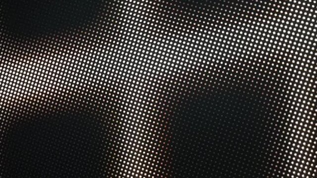 Close-up of the LCD screen pixels. Abstract background. Close the color-coded LED display. RGB pixels on a TV while a movie is being shown. Red, blue and green subpixels create an image on the screen