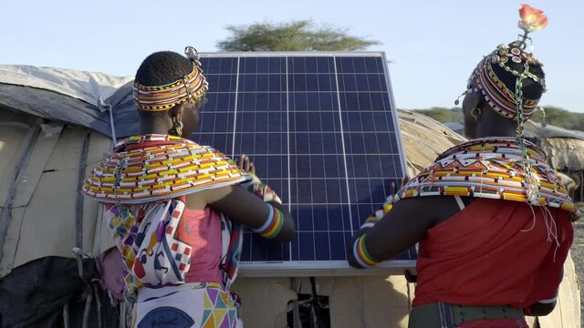 Women from the Samburu tribe in Kenya, installing solar panels to generate electricity in their village. 