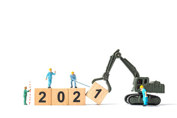 Miniature Worker team create wooden block number 2021