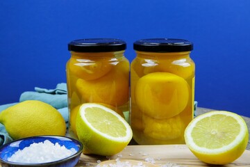 Preparation of moroccan preserved pickled salt lemons: Close up of isolated sliced yellow citrus...