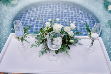 two glasses with champagne and other attributes for the wedding ceremony in Phuket, Thailand. Background image wedding.