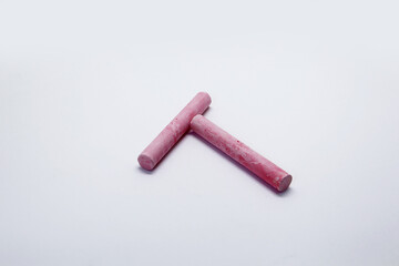 Colored chalk, in the form of small elongated cylinders in a wide variety of colors, used as school supplies for writing or drawing on a blackboard.