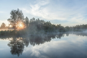 Fototapeta na wymiar River before sunrise in the fog