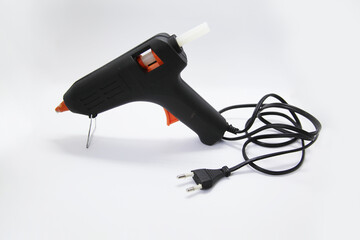 Hot glue gun, an electrical instrument used to apply hot glue to various materials, especially in...