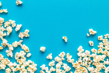 Popcorn frame on blue background top view copy space