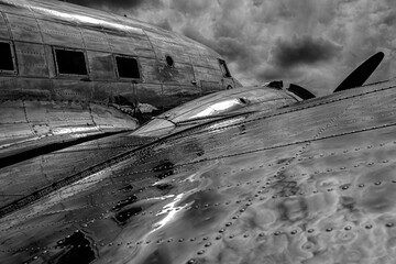 Black and white HDR image of the metal skin of a vintage piston propeller airliner.