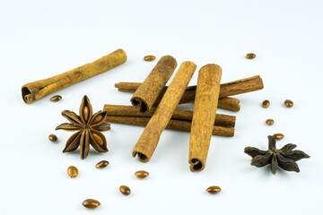 Cinnamon sticks, stars and anise seeds isolated on a white background.