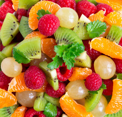Fresh fruit salad with with raspberry, mandarin and other fruit