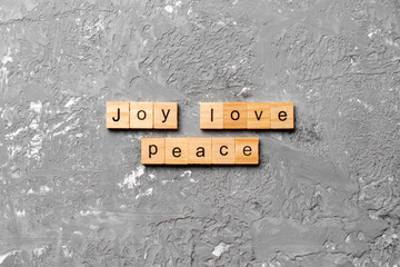 joy love peace word written on wood block. joy love peace text on cement table for your desing, concept