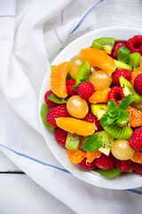 Fresh fruit salad with with raspberry, mandarin and other fruit