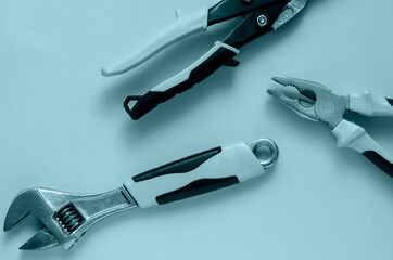 Creative background with hand tools in turquoise colors.