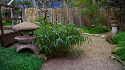 green japanese garden with beautiful stone sconce