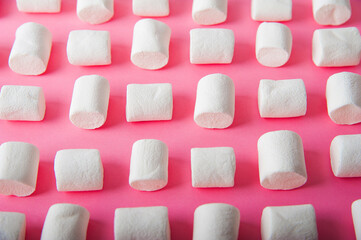 Marshmallows close-up and copy space on a pink background. 