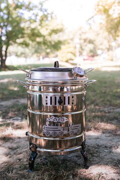 Vertical shot of a Spanish kitchen appliance "Putxera" on the ground under sunlight
