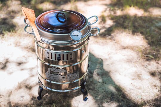 High angle shot of a Spanish kitchen appliance "Putxera" on the ground under sunlight