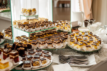 Sweet cakes at a wedding buffet. Catering