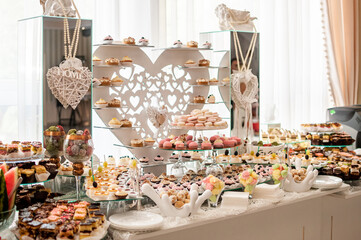 Sweet cakes at a wedding buffet. Catering