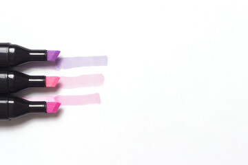 three markers with their examples isolated on white background