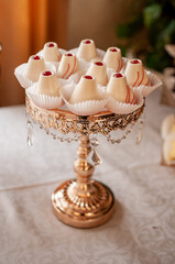 Sweet cakes at a wedding buffet. Catering