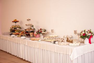 Sweet cakes at a wedding buffet. Catering