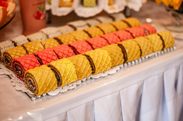 Sweet cakes at a wedding buffet. Catering