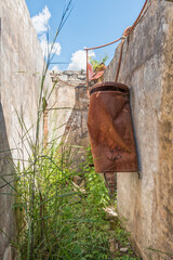 Rusted hot water geyser in ruins of Royal Natal hotel