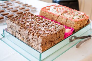 Sweet cakes at a wedding buffet. Catering