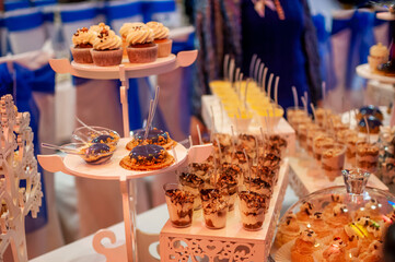 Sweet cakes at a wedding buffet. Catering