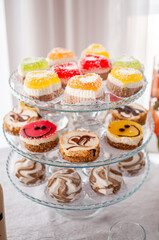 Sweet cakes at a wedding buffet. Catering