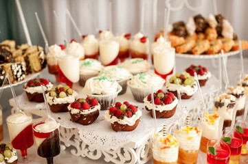 Sweet cakes at a wedding buffet. Catering