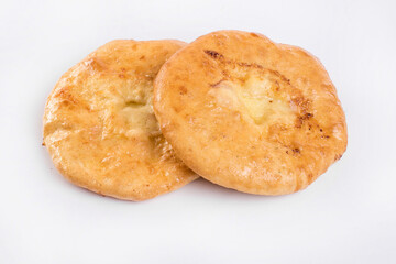 Delicious Georgian khachapuri - closed baked pie with homemade cheese isolated on white background
